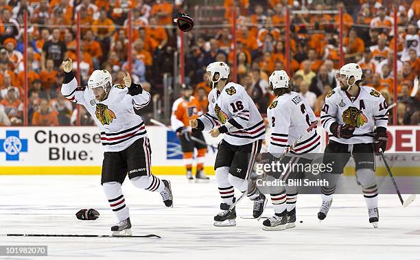 Patrick Kane of the Chicago Blackhawks skates in victory toward goalie Antti Niemi after scoring the winning goal against the Philadelphia Flyers to...