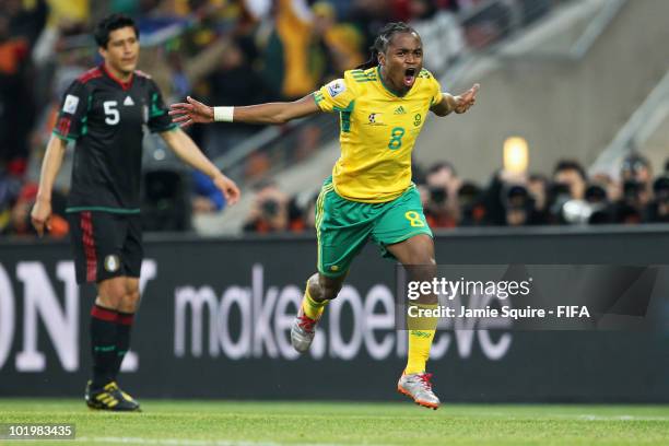 Siphiwe Tshabalala of South Africa celebrates after scoring the opening goal while Ricardo Osorio of Mexico looks dejected during the 2010 FIFA World...