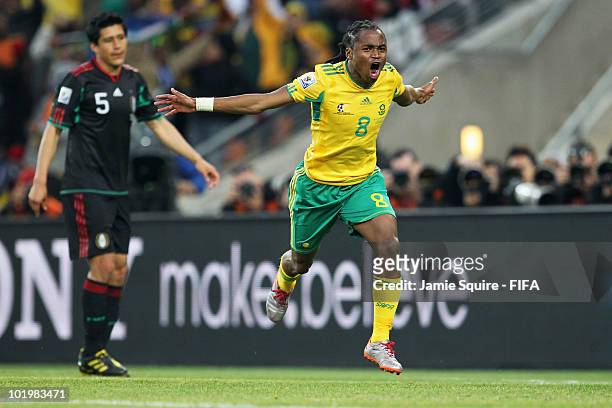 Siphiwe Tshabalala of South Africa celebrates after scoring the opening goal while Ricardo Osorio of Mexico looks dejected during the 2010 FIFA World...