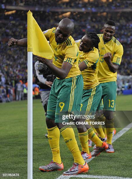 South Africa's striker Katlego Mphela and midfielder Kagisho Dikgacoi celebrate after midfielder teammate Siphiwe Tshabalala scored the opening goal...