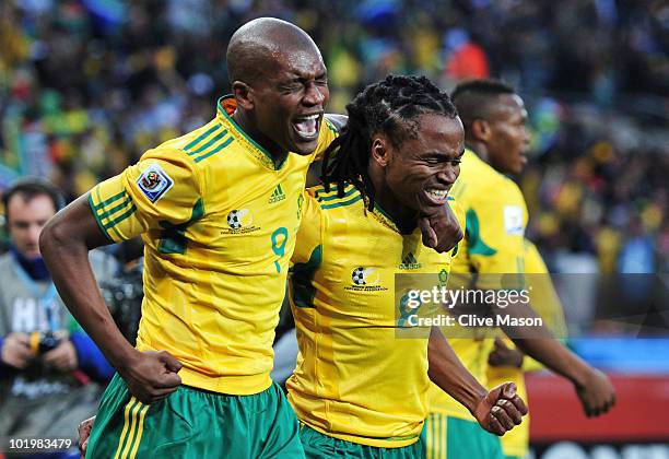 Siphiwe Tshabalala of South Africa celebrates scoring the first goal with team mate Katlego Mphela during the 2010 FIFA World Cup South Africa Group...