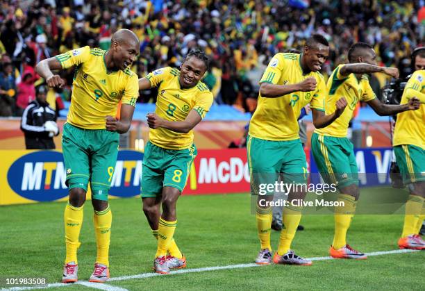 Siphiwe Tshabalala of South Africa celebrates scoring the first goal with team mates during the 2010 FIFA World Cup South Africa Group A match...