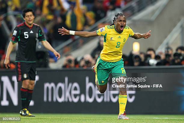 Siphiwe Tshabalala of South Africa celebrates after scoring the opening goal while Ricardo Osorio of Mexico looks dejected during the 2010 FIFA World...