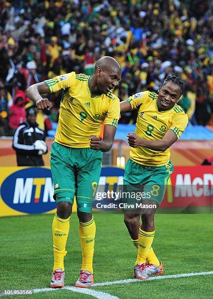 Siphiwe Tshabalala of South Africa celebrates scoring the first goal with team mates during the 2010 FIFA World Cup South Africa Group A match...