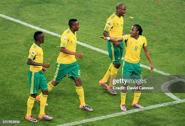 Siphiwe Tshabalala of South Africa celebrates scoring the first goal with team mates during the 2010 FIFA World Cup South Africa Group A match...