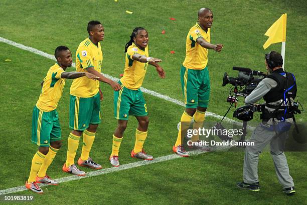 Siphiwe Tshabalala of South Africa celebrates scoring the first goal with team mates during the 2010 FIFA World Cup South Africa Group A match...