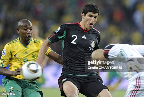 South Africa's striker Katlego Mphela tries for a chance on goal as Mexico's defender Francisco Rodriguez and Mexico's goalkeeper Oscar Perez defend...
