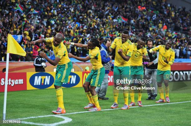 Siphiwe Tshabalala of South Africa celebrates scoring the first goal with team mates during the 2010 FIFA World Cup South Africa Group A match...