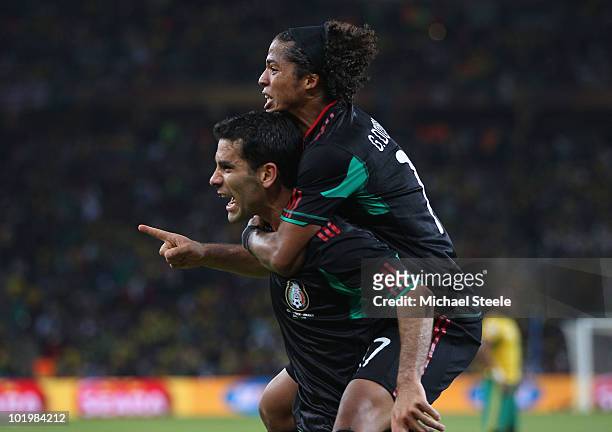 Giovani Dos Santos of Mexico celebrates with Rafael Marquez of Mexico after he scored the second goal to equalise during the 2010 FIFA World Cup...
