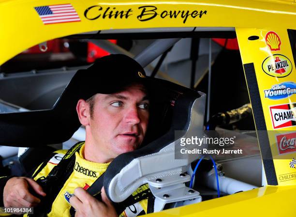 Clint Bowyer, driver of the Cheerios/Hamburger Helper Chevrolet, sits in his car prior to practice for the NASCAR Sprint Cup Series Heluva Good! Sour...