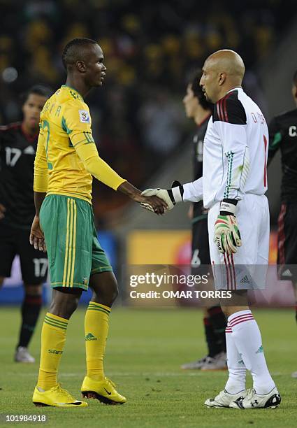 Mexico's goalkeeper Oscar Perez shakes hands with South Africa's defender Siboniso Gaxa at the end of their Group A first round 2010 World Cup...
