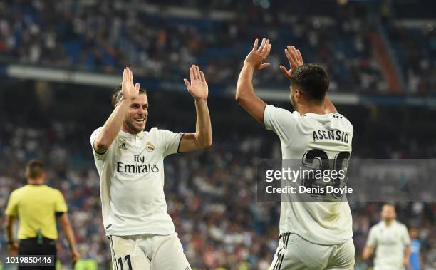 Gareth Bale of Real Madrid celebrates with Marco Asensio after scoring his teams second goal during the La Liga match between Real Madrid CF and...