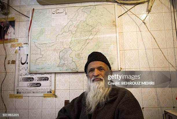 Pakistani man Abdul Sattar Edhi, The founder of The Edhi Charity Foundation sits in his office under a map of Pakistan in Karachi on February 20,...