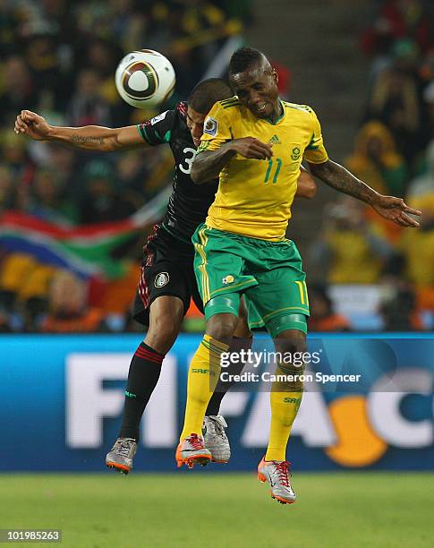 Carlos Salcido of Mexico goes up for a challenge with Teko Modise of South Africa during the 2010 FIFA World Cup South Africa Group A match between...