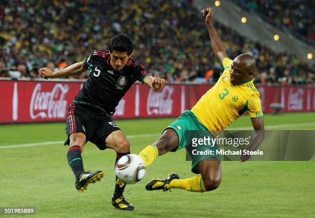 Tsepo Masilela of South Africa challenges Ricardo Osorio of Mexico during the 2010 FIFA World Cup South Africa Group A match between South Africa and...