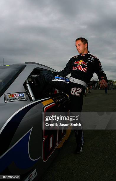 Scott Speed, driver of the Red Bull Toyota, climbs in his car prior to practice for the NASCAR Sprint Cup Series Heluva Good! Sour Cream Dips 400 at...