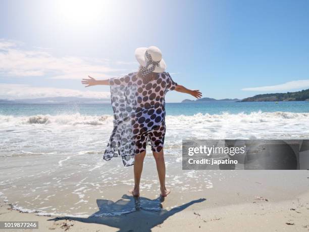 beautiful woman enjoying a day at the beach in the cies islands. pontevedra galicia. spain - sarong stock pictures, royalty-free photos & images