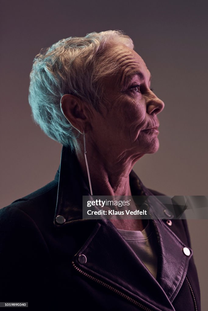 Profile portrait of cool mature woman, with coloured lights