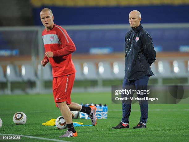 Manager Bob Bradley looks on as Michael Bradley trains during the USA training session at the Royal Bafokeng Stadium on June 11, 2010 in Rustenburg,...