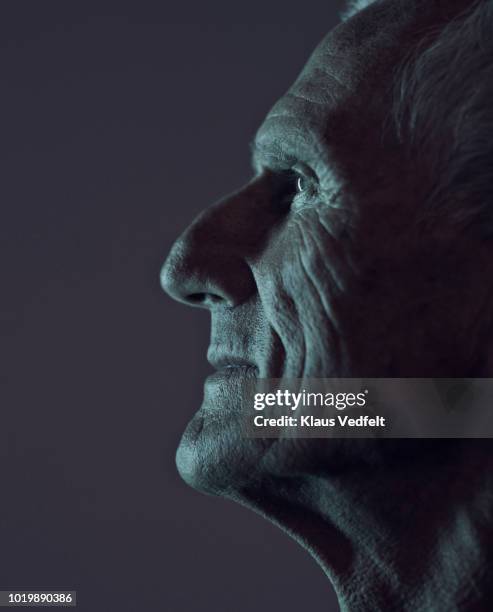 profile portrait of cool mature man, with coloured lights - anticipation face stock pictures, royalty-free photos & images