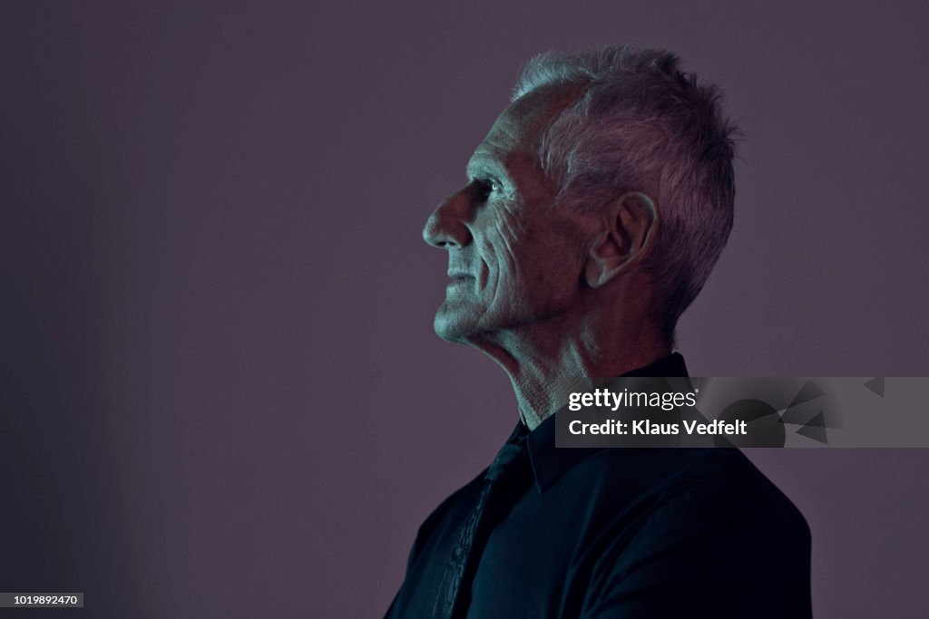 Profile portrait of cool mature man, with coloured lights