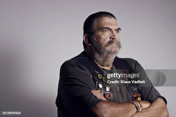 mature rough looking man photographed on studio with hard lighting - biker photos et images de collection