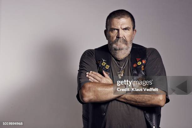 mature rough looking man photographed on studio with hard lighting - biker fotografías e imágenes de stock