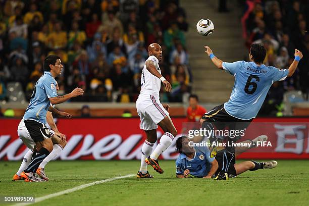 Nicolas Anelka of France tries to score against Mauricio Victorino of Uruguay while Diego Godin of Uruguay looks on during the 2010 FIFA World Cup...