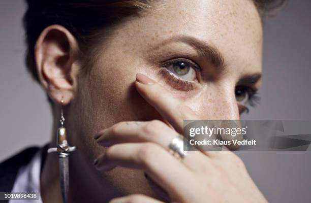 close-up of beautiful young woman's hand and eye, shot on studio - occhi verdi foto e immagini stock