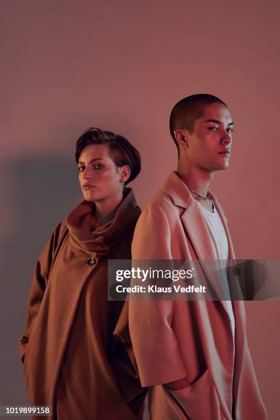 two beautiful young people looking in camera - attitude stock pictures, royalty-free photos & images