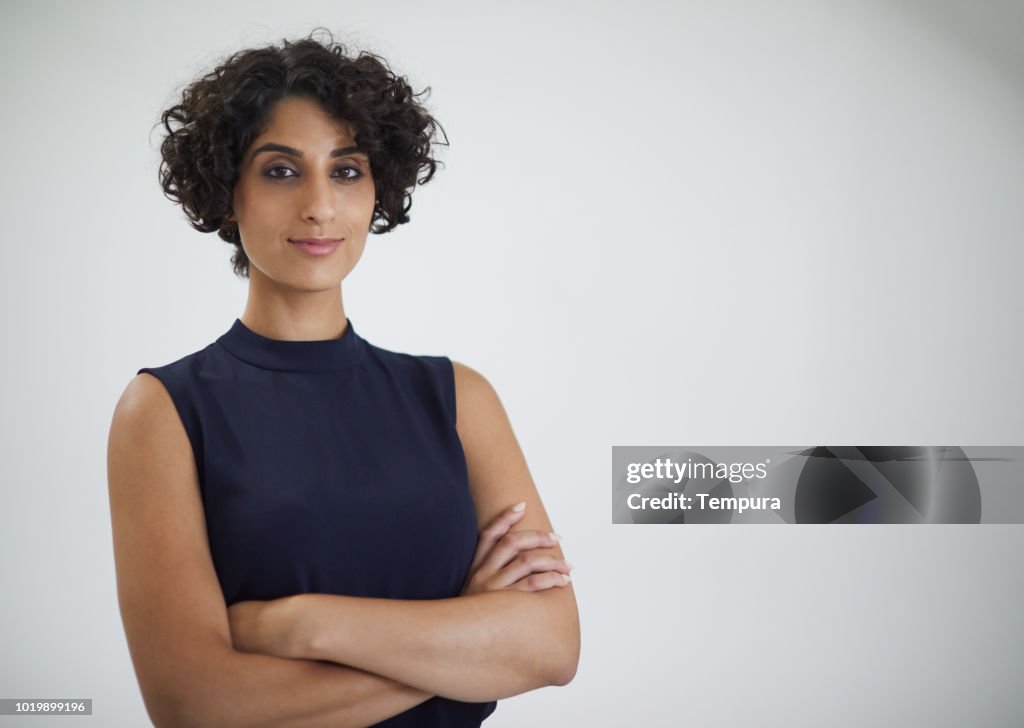 Studio headshot of confident businesswoman looking at camera.