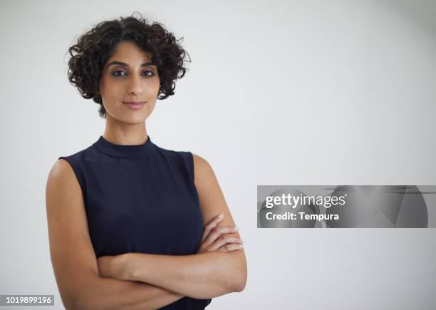 studio headshot of confident businesswoman looking at camera. - plain grey backgrounds stock pictures, royalty-free photos & images