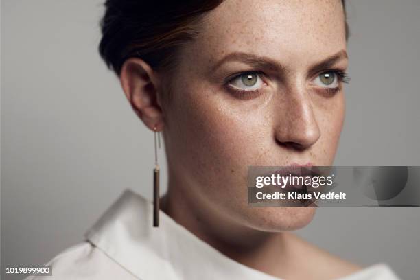 portrait of beautiful young woman looking in camera, shot on studio - determination look stock pictures, royalty-free photos & images