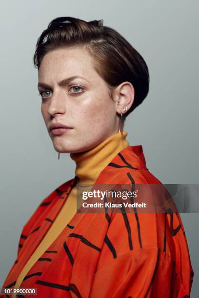 portrait of beautiful young woman, shot on studio - stylish man looking away stock-fotos und bilder