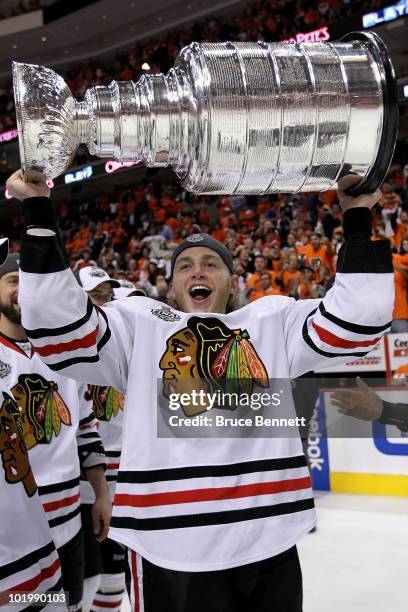 Patrick Kane of the Chicago Blackhawks hoists the Stanley Cup after scoring the game-winning goal in overtime to defeat the Philadelphia Flyers 4-3...