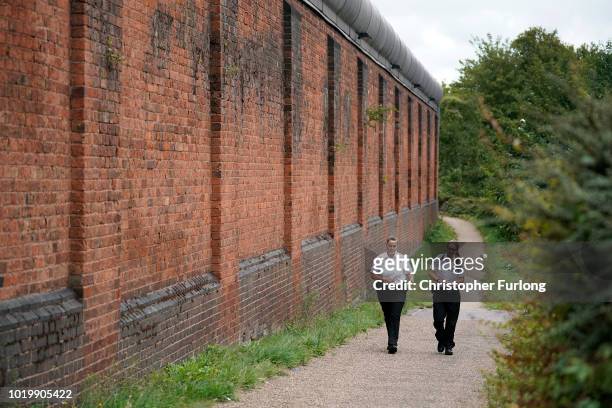 Prison officers walk past Birmingham Prison in Winson Green on August 20, 2018 in Birmingham, England. Birmingham Prison, formerly Winson Green...