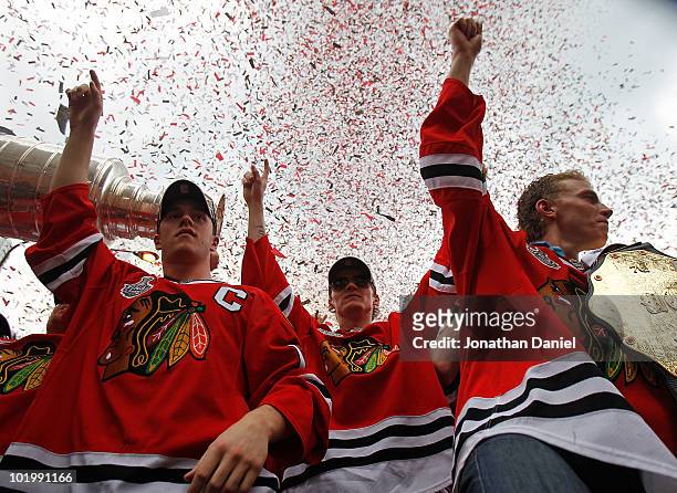 Jonathan Toews, Tomas Kopecky and Patrick Kane celebrate with the crowd during the Chicago Blackhawks Stanley Cup victory parade and rally on June...