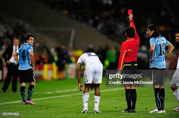 Nicolas Lodeiro of Uruguay is shown a red card by Referee Yuichi Nishimura during the 2010 FIFA World Cup South Africa Group A match between Uruguay...