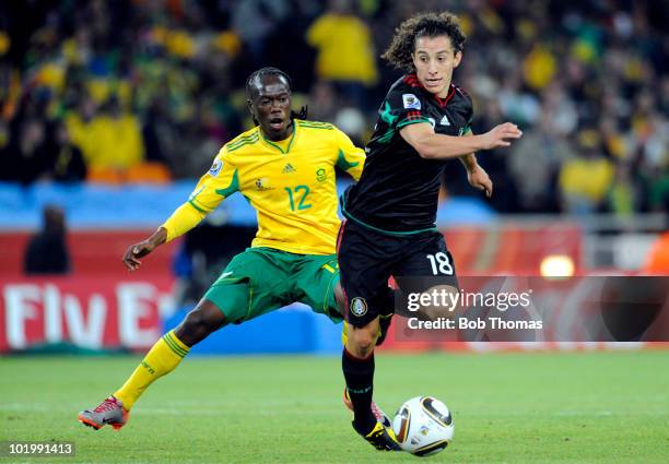 Andres Guardado of Mexico vies for the ball with Reneilwe Letsholonyane of South Africa during the 2010 FIFA World Cup South Africa Group A match...