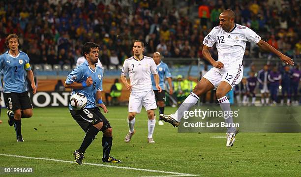 Thierry Henry of France takes a shot on goal which is blocked by Mauricio Victorino of Uruguay during the 2010 FIFA World Cup South Africa Group A...