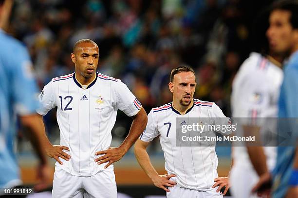 Thierry Henry and Franck Ribery of France look dejected during the 2010 FIFA World Cup South Africa Group A match between Uruguay and France at Green...