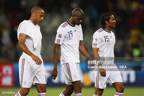 Thierry Henry, Abou Diaby and Florent Malouda of France leave the pitch after the 2010 FIFA World Cup South Africa Group A match between Uruguay and...