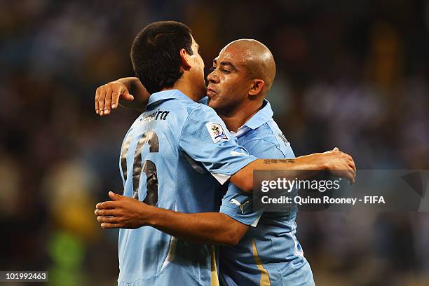 Maximiliano Pereira and Egidio Arevalo Rios of Uruguay hug after the 2010 FIFA World Cup South Africa Group A match between Uruguay and France at...