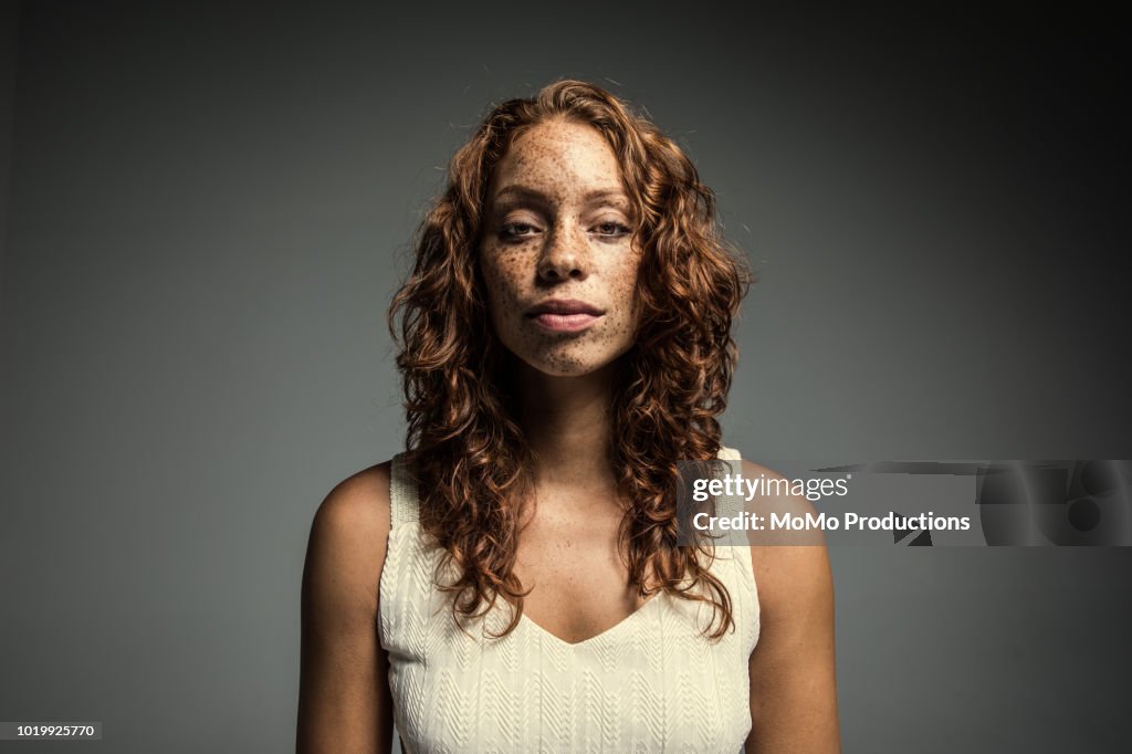 Studio portrait of woman with freckles