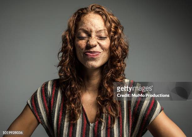 studio portrait of woman with freckles - humeur photos et images de collection