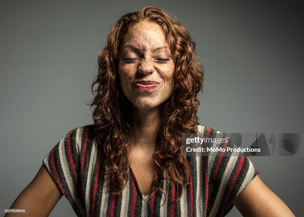 Studio portrait of woman with freckles