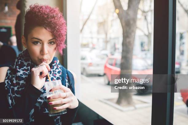 short haired girl in cafe - half shaved hair stock pictures, royalty-free photos & images