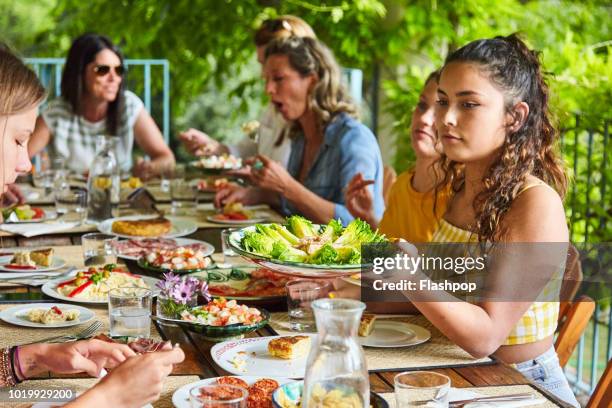 al fresco dining - friends sharing mediterranean fotografías e imágenes de stock