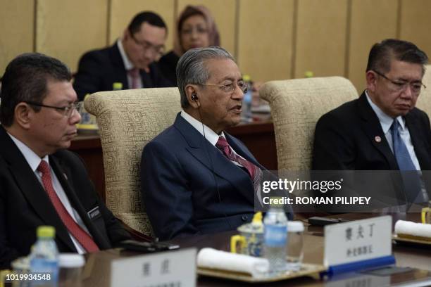 Malaysian Prime Minister Mahathir Mohamad speaks to Chinese President Xi Jinping during their meeting at Diaoyutai State Guesthouse in Beijing on...