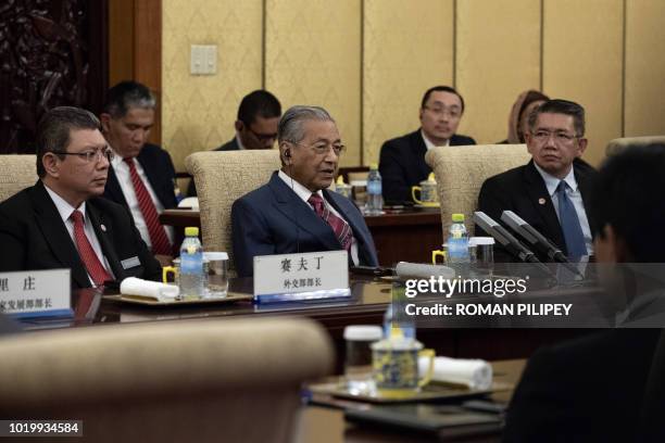 Malaysian Prime Minister Mahathir Mohamad speaks to Chinese President Xi Jinping during their meeting at Diaoyutai State Guesthouse in Beijing on...